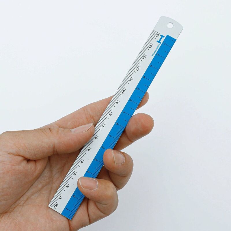 Hand holding a blue ruler against a white background