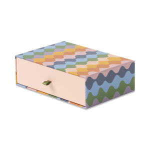 Colorful geometric-patterned box on a white background
