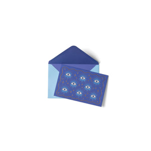 Blue card with eye pattern and matching envelope on a white background