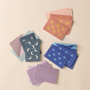 Stacks of colorful greeting cards with various patterns on a beige background