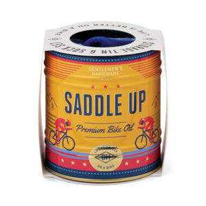 Can of 'Saddle Up' premium bike oil with colorful design and text on a white background