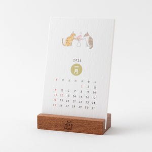 Calendar with wooden stand featuring illustrations of cats and the year 2026 on a white background.
