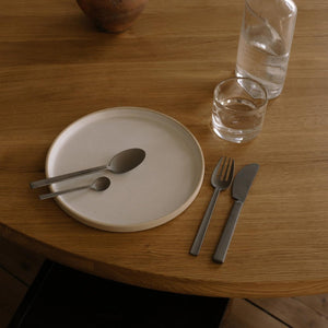 FRAMA X OLE PALSBY CUTLERY on wooden table with plates and glasses