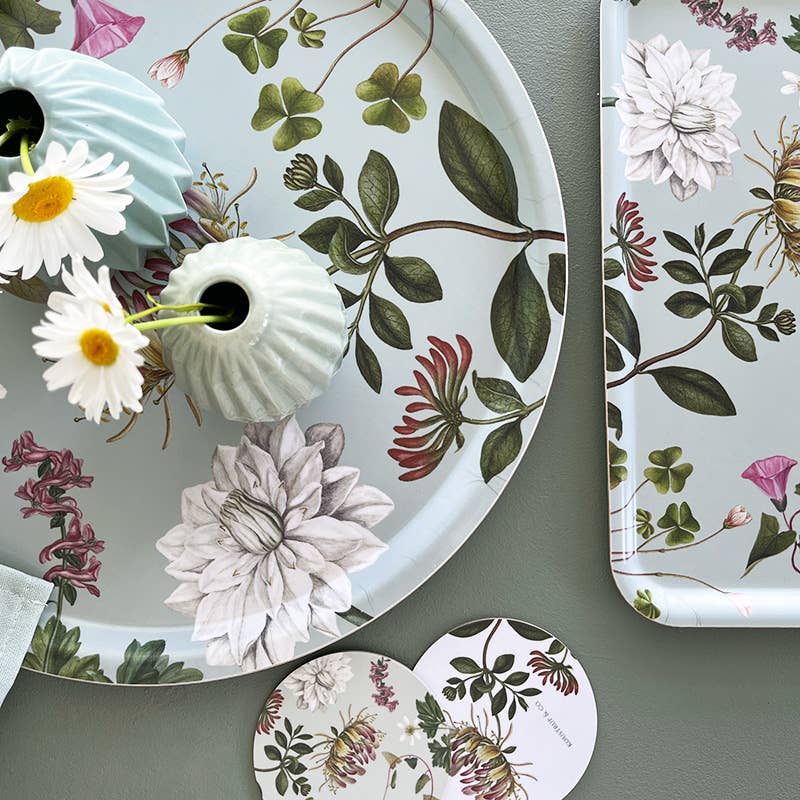 Decorative plates with floral and nature-themed designs on a gray surface.