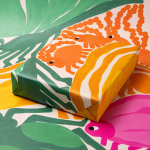 Colorful gift box with crab design on a patterned background