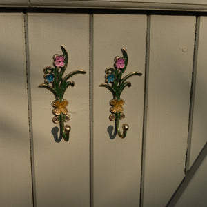 Decorative floral hooks on a wooden surface