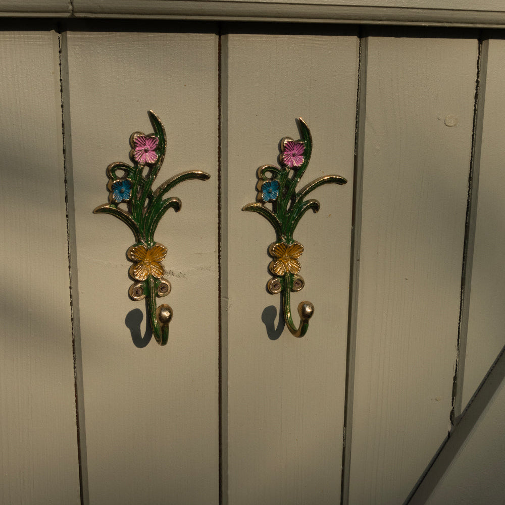 Decorative floral hooks on a wooden surface