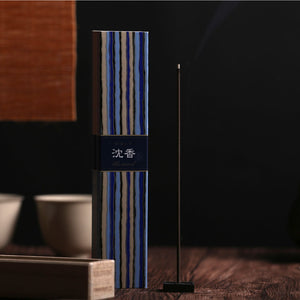 Incense stick with striped packaging on a dark background