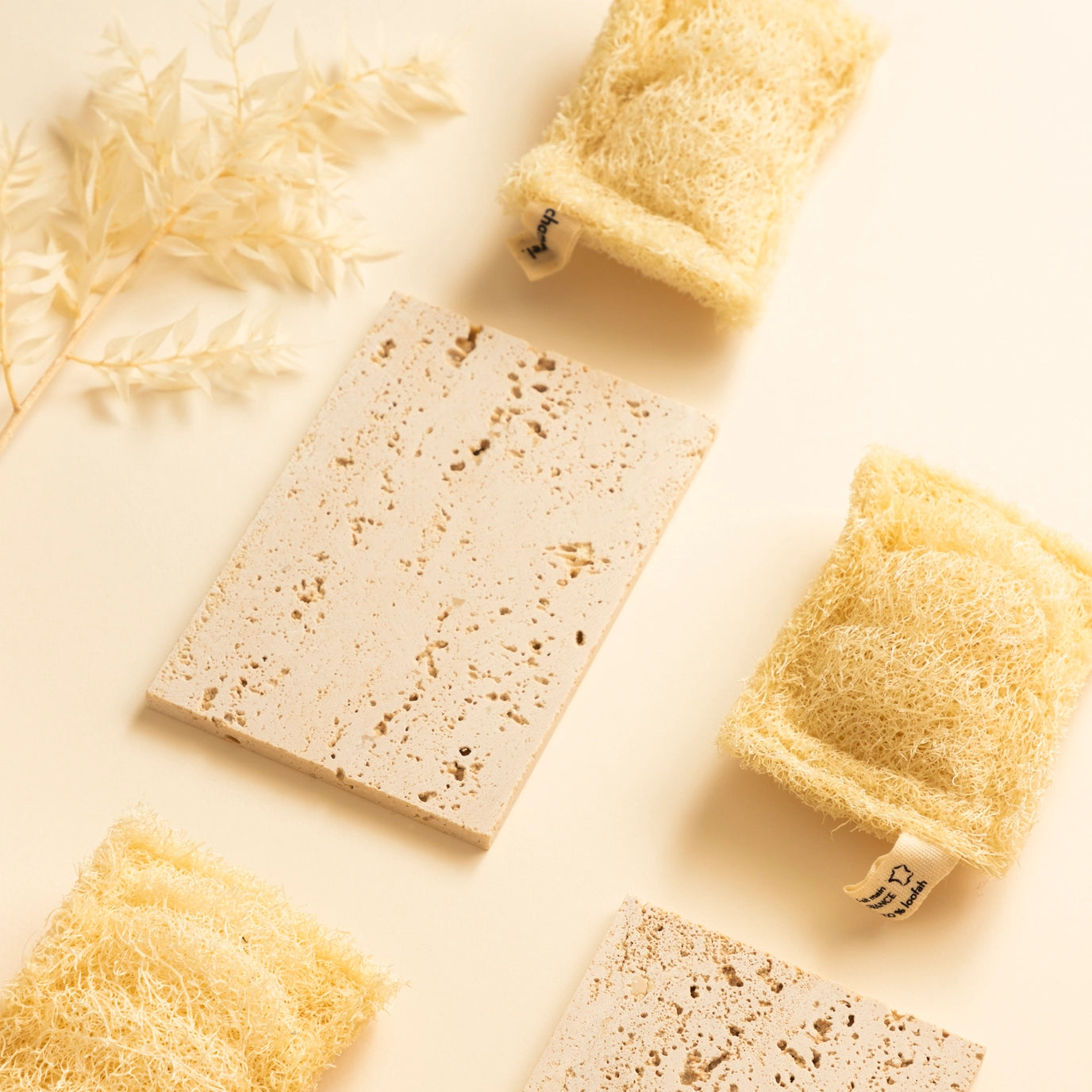 Various natural sponges and soap bars on a light background