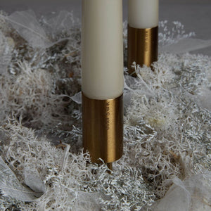 gold candle stick on xmas wreath with candles