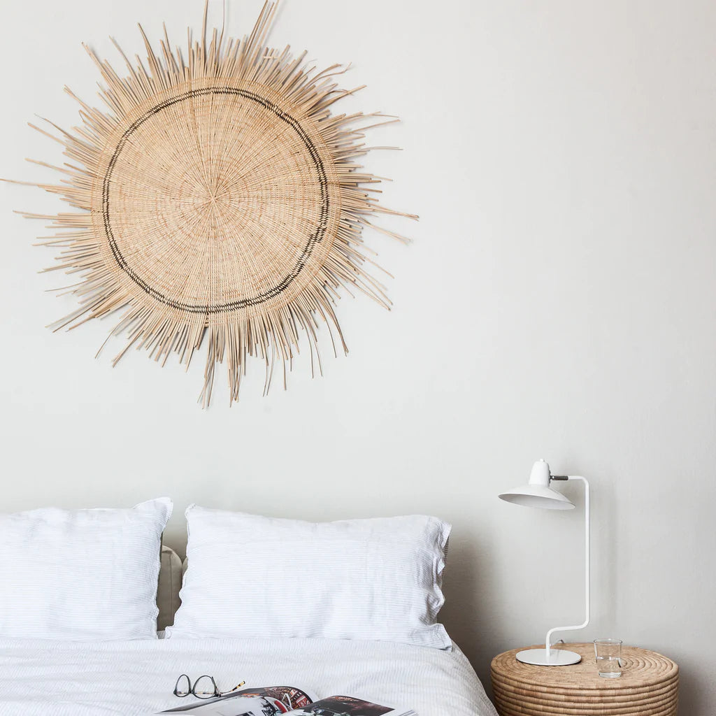 natural colour sun circle wall decor hang on top of a bed