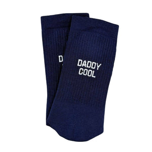 Navy blue socks with 'Daddy Cool' text on a light gray background