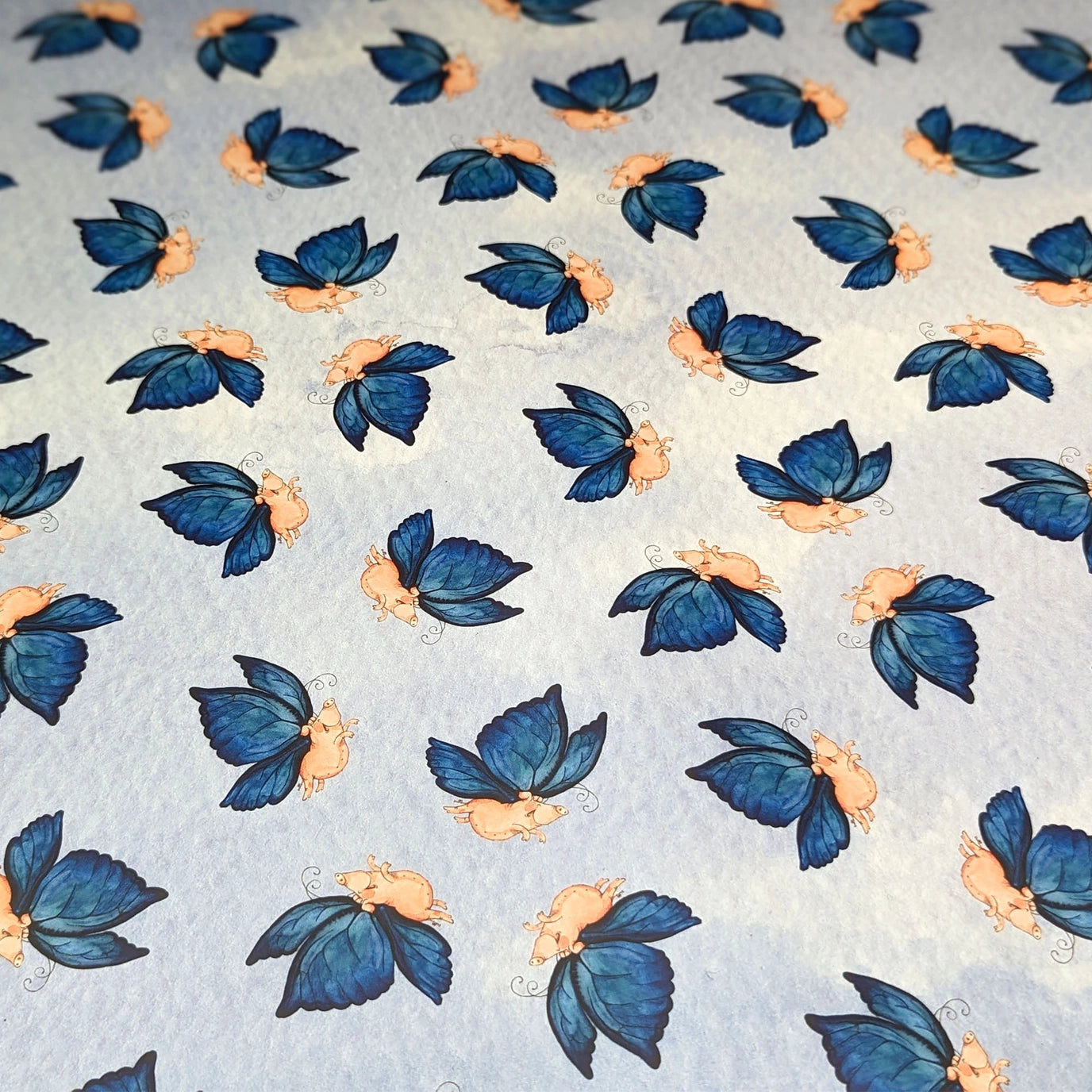 Gift box with blue butterfly pattern and purple ribbon on a matching background