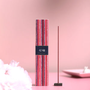 Striped incense stick with a label on a pink background