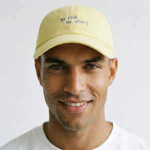 Man wearing a yellow cap with text on a white background