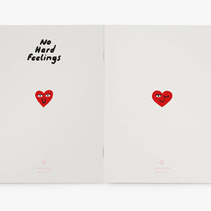 Open notebook with red hearts and text on a white background