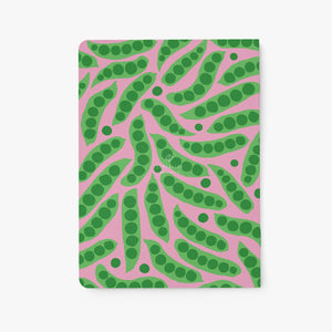 Notebook with green leaf pattern on a pink background