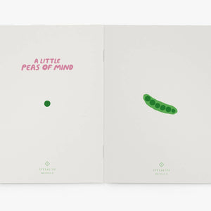 Open notebook with a green pea illustration and text on a white background