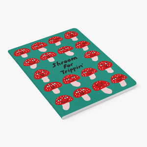 Notebook with red and white mushroom pattern on a teal background