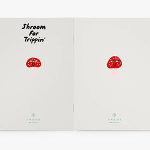 Open notebook with red shroom illustrations and text on a white background