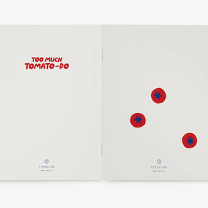 Open notebook with red text and tomato-themed stickers on a white background