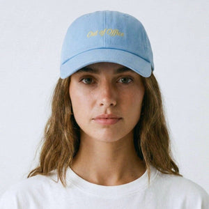 Person wearing a light blue cap with text on a white background