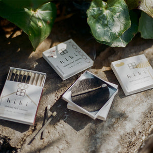 hibi matches and packaging on a stone surface with leaves