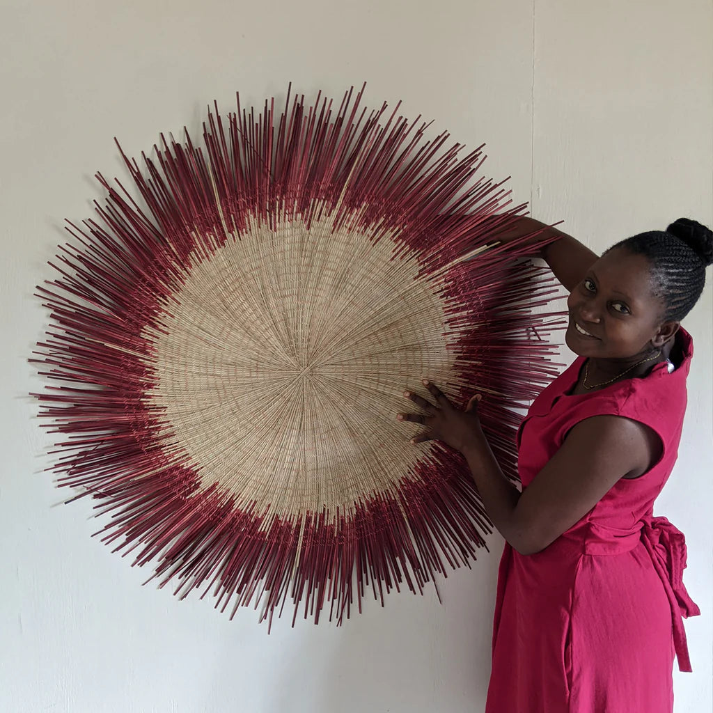 wall decor sun circles in red hang on wall outside on top of pillows and bench